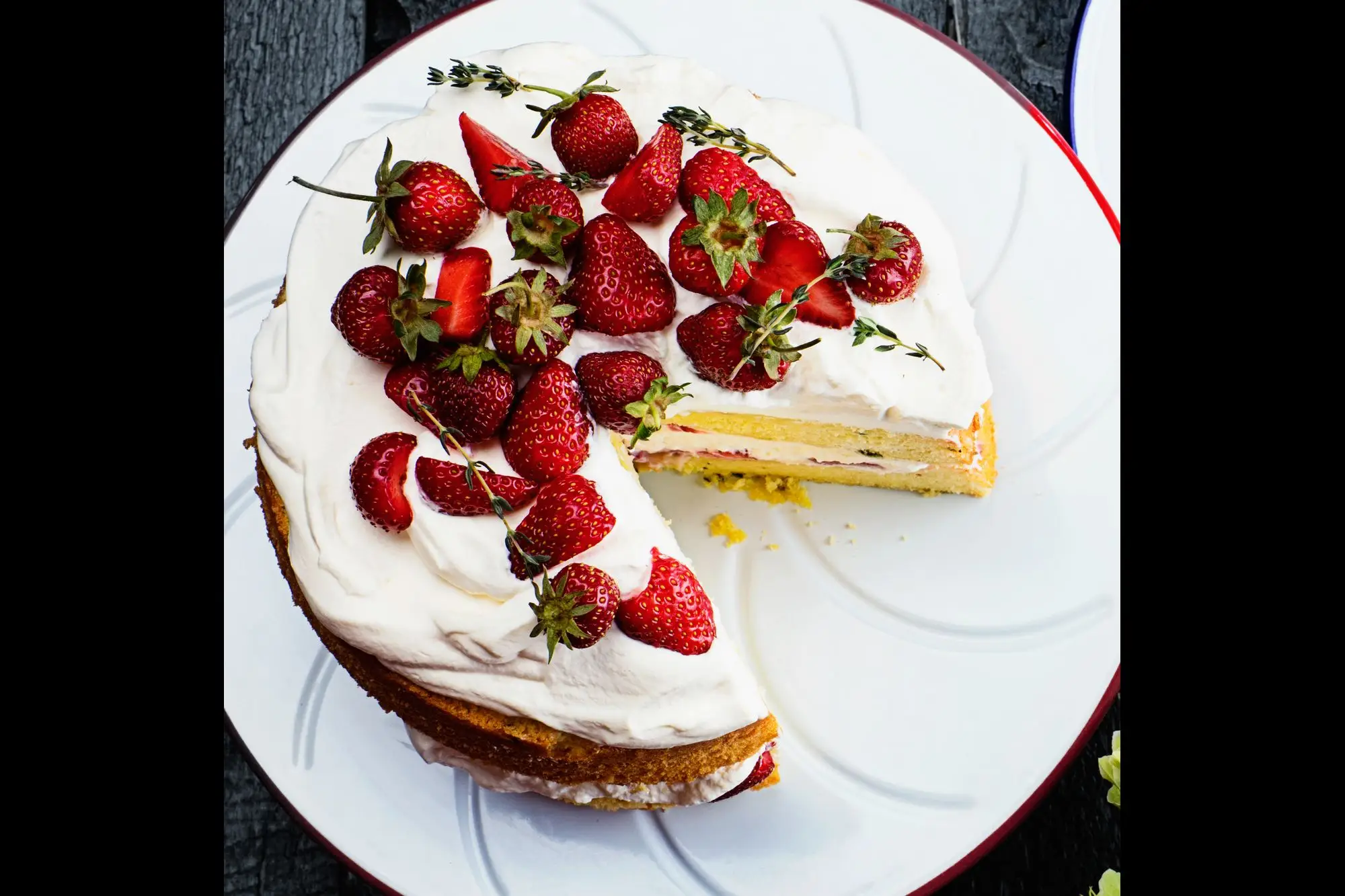 Strawberry shortcake on a plate with two slices next to it.