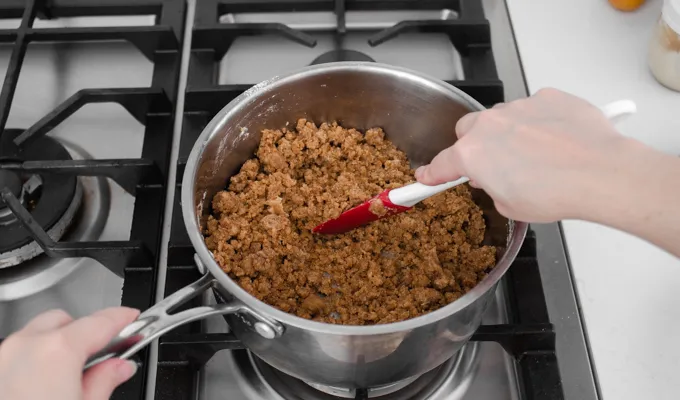 Stirring with a spatula to make coarse crumbs.' title='Strawberry Rhubarb Crumb Cake