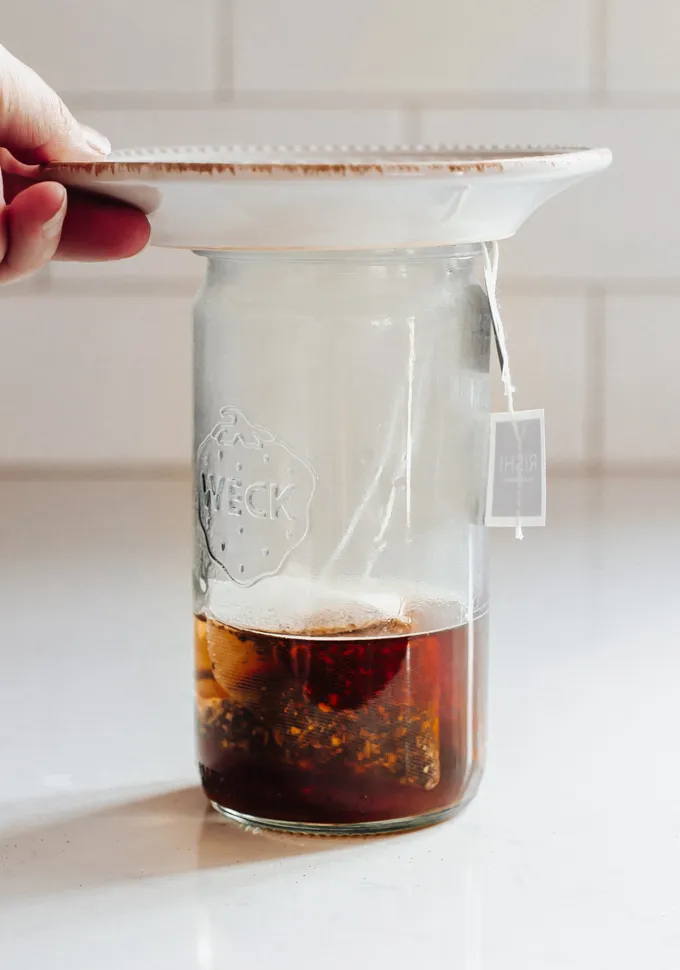 Putting a plate on top of a Weck jar while brewing tea.' title='Iced Chai Latte Recipe