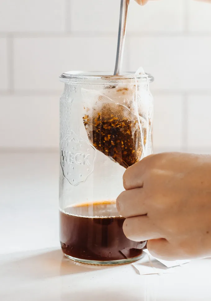 Squeezing out tea bags.' title='Iced Chai Latte Recipe