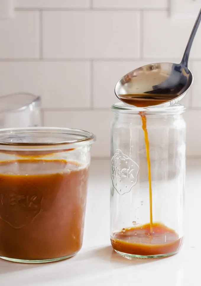 Ladling the homemade chai concentrate into a Weck jar for serving.' title='Iced Chai Latte Recipe