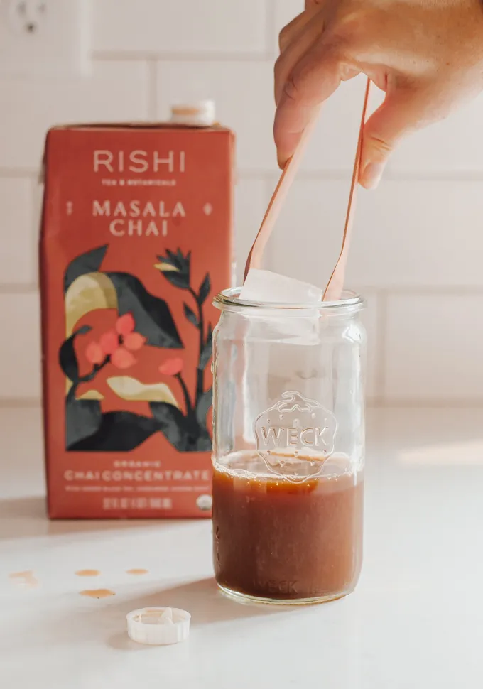Adding ice to a jar of chai tea concentrate.' title='Iced Chai Latte Recipe
