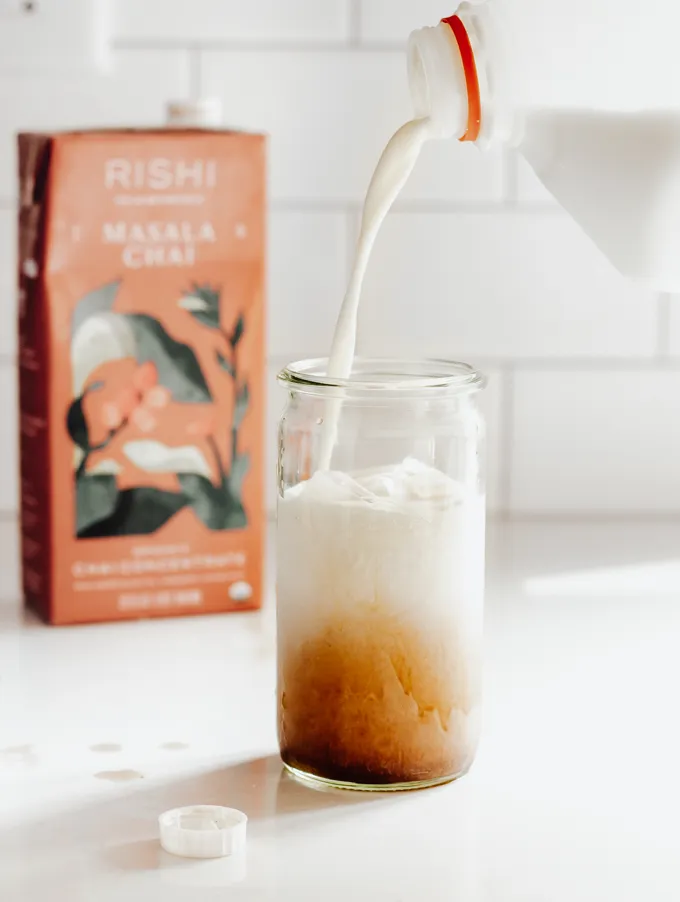 Adding a splash of whole milk.' title='Iced Chai Latte Recipe
