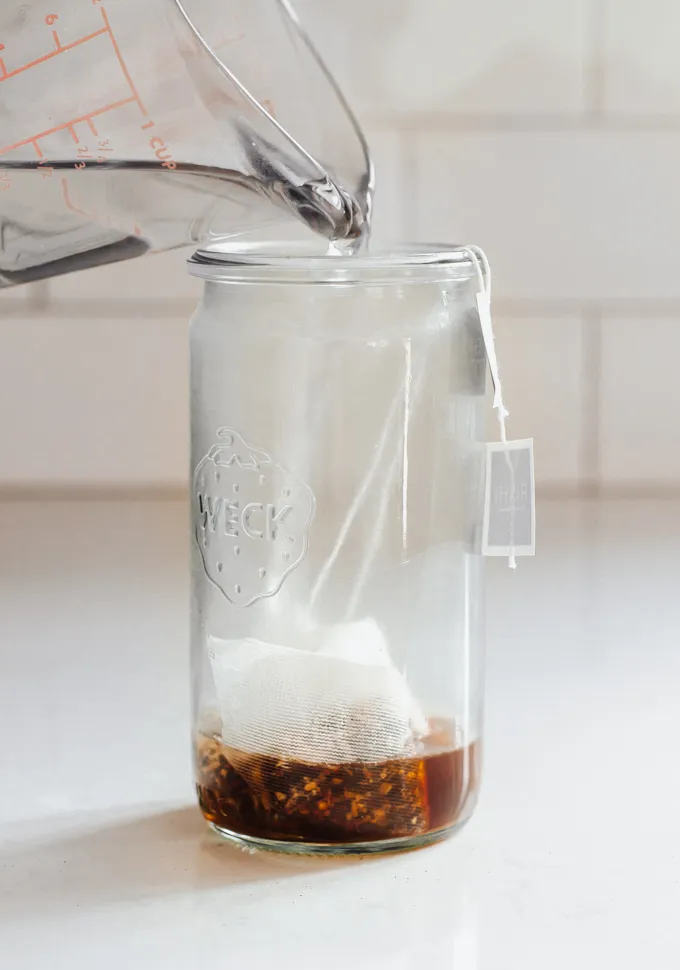 Making an iced chai tea latte with tea bags.' title='Iced Chai Latte Recipe