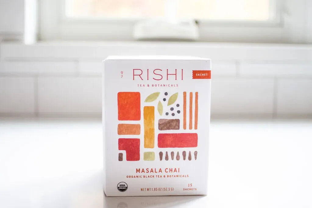 Rishi Masala Chai on a white countertop with a window in the background.' title='Best Organic Chai Tea
