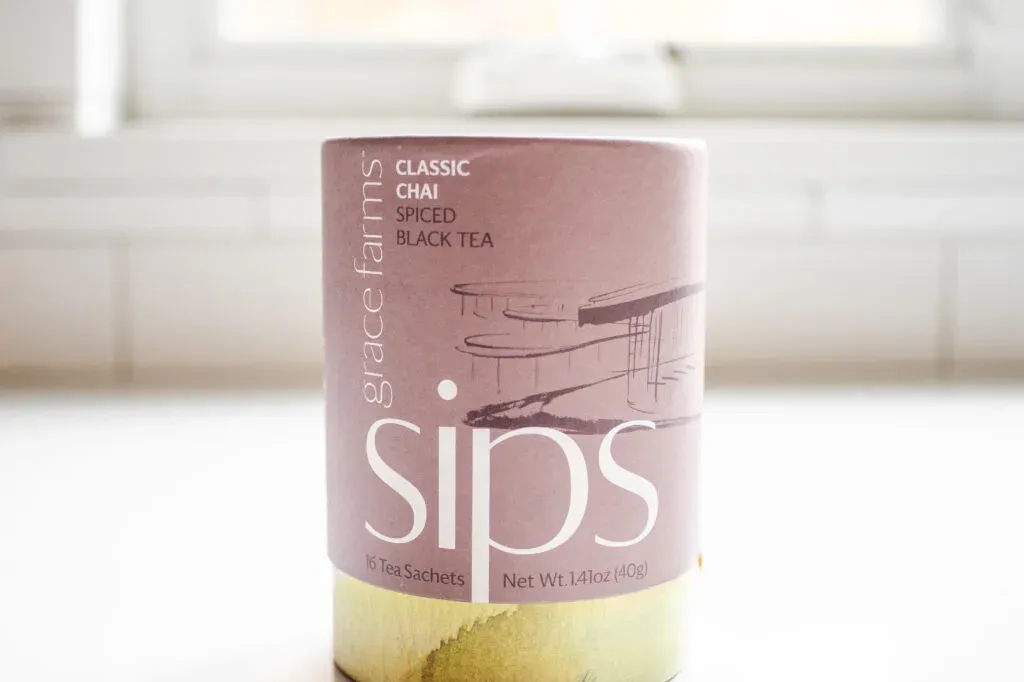 Sips organic chai tea on a white countertop.' title='Best Organic Chai Tea