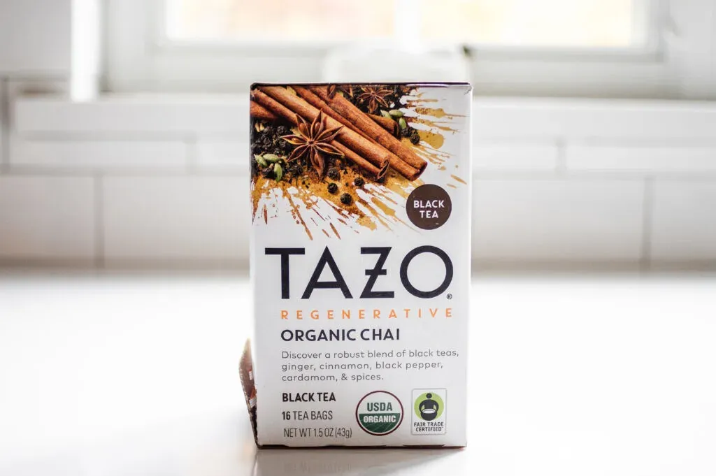 TAZO organic chai tea on a white countertop.' title='Best Organic Chai Tea