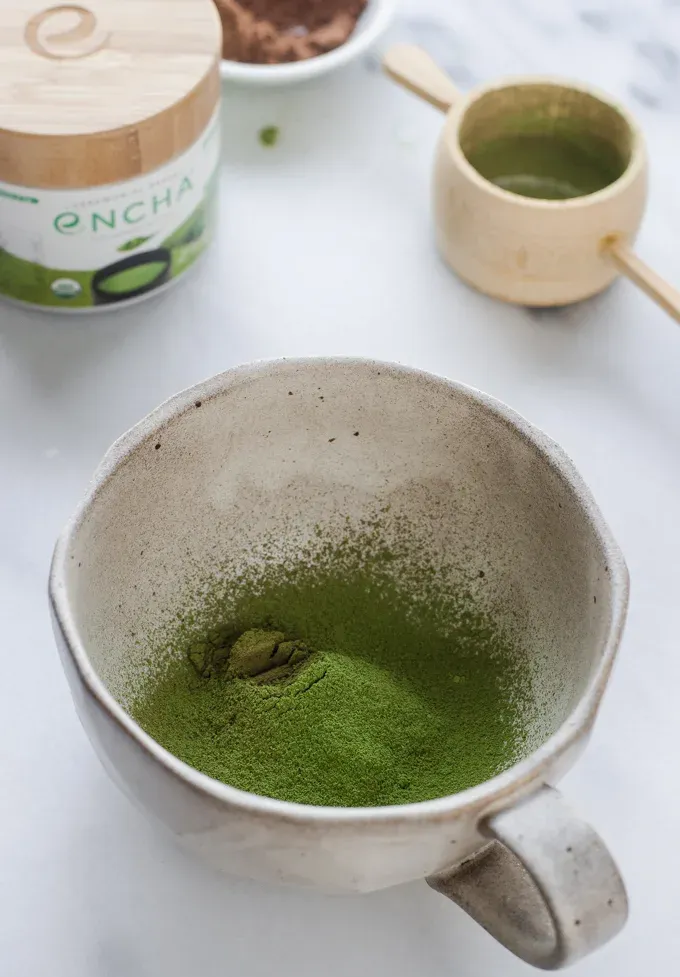 The sifted matcha and cocoa powder in a mug.' title='Matcha Cocoa