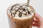 A copycat Starbucks double chocolate chip frappuccino in a 16 ounce glass with a stainless steel straw.' title='Double Chocolate Chip Frappuccino Recipe 