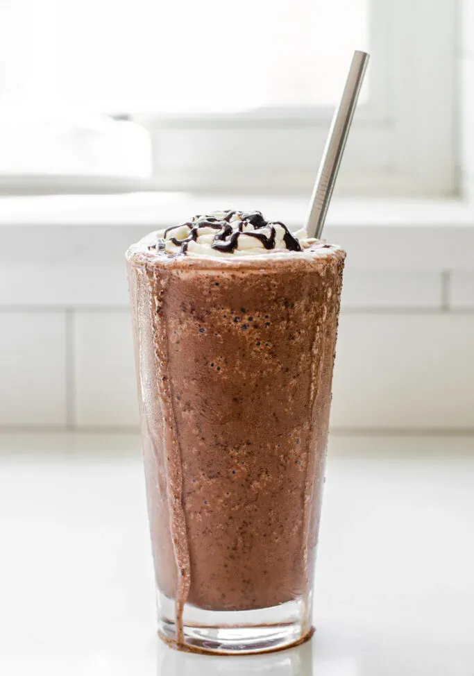 A copycat Starbucks double chocolate chip frappuccino in a 16 ounce glass with a stainless steel straw.' title='Double Chocolate Chip Frappuccino Recipe 