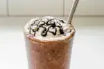 A copycat Starbucks double chocolate chip frappuccino in a 16 ounce glass with a stainless steel straw.' title='Double Chocolate Chip Frappuccino Recipe 