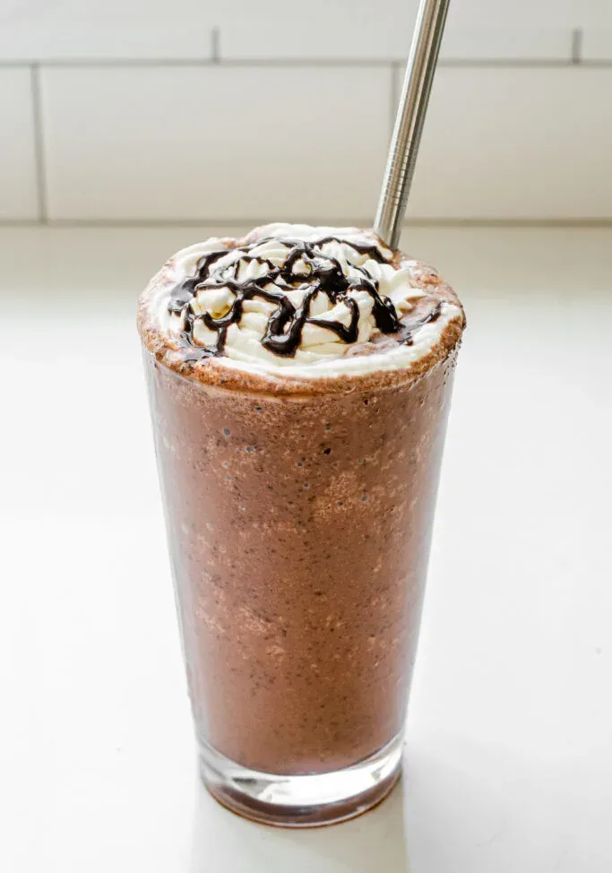 A 16 ounce glass of my copycat Starbucks Double Chocolate Chip Frappuccino recipe with a stainless steel straw.' title='Double Chocolate Chip Frappuccino Recipe 