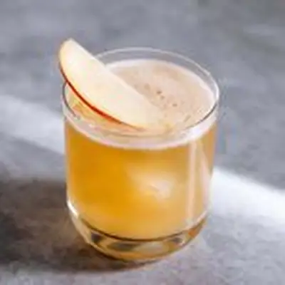 Cider Delighter cocktail in a rocks glass with apple slice garnish