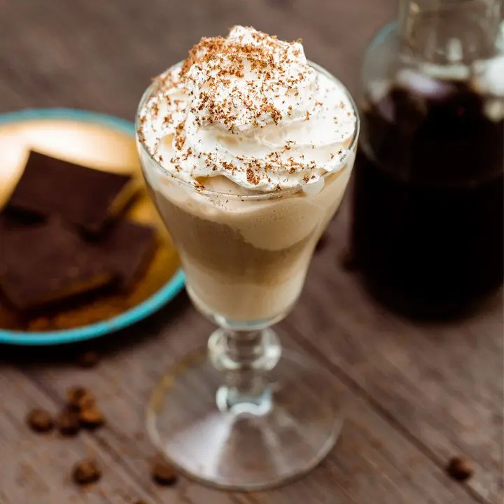Irish Affogato cocktail in an Irish Coffee glass, topped with whipped cream and chocolate shavings