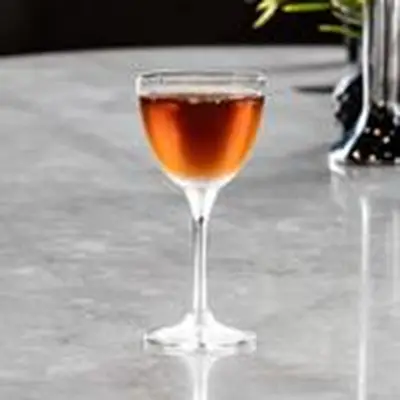 amber-colored High Seas cocktail served in a Nick and Nora glass