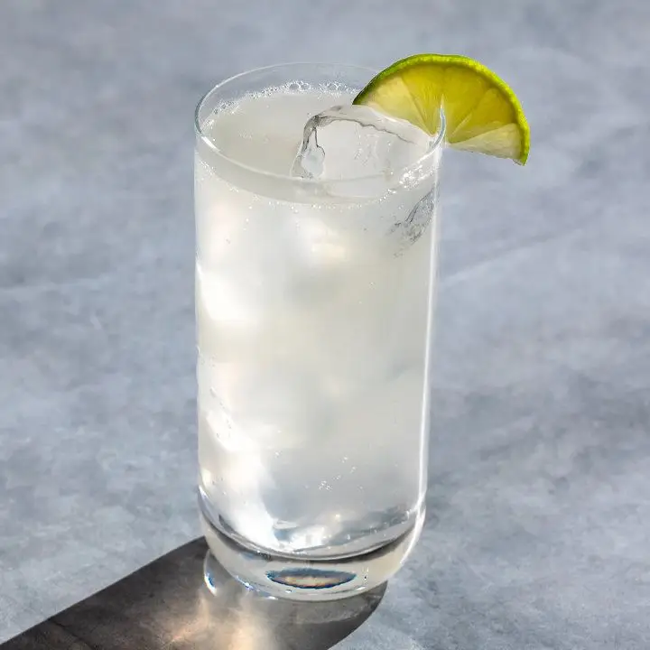 Mule cocktail in a Collins glass with ice, garnished with a lime wedge