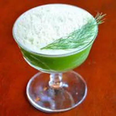 bright-green Snap, Chat & Rum cocktail in a coupe, garnished with a fennel frond