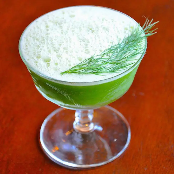 bright-green Snap, Chat & Rum cocktail in a coupe, garnished with a fennel frond