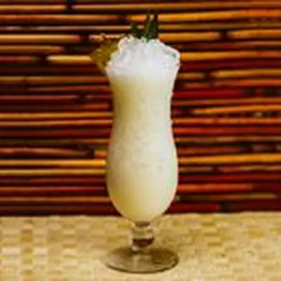 pina colada cocktail in a hurricane glass with crushed ice 