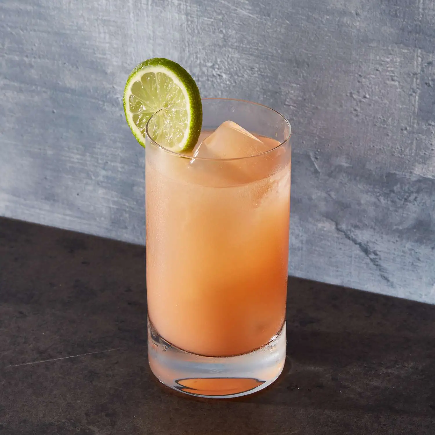 Greyhound cocktail in Collins glass with lime wheel garnish