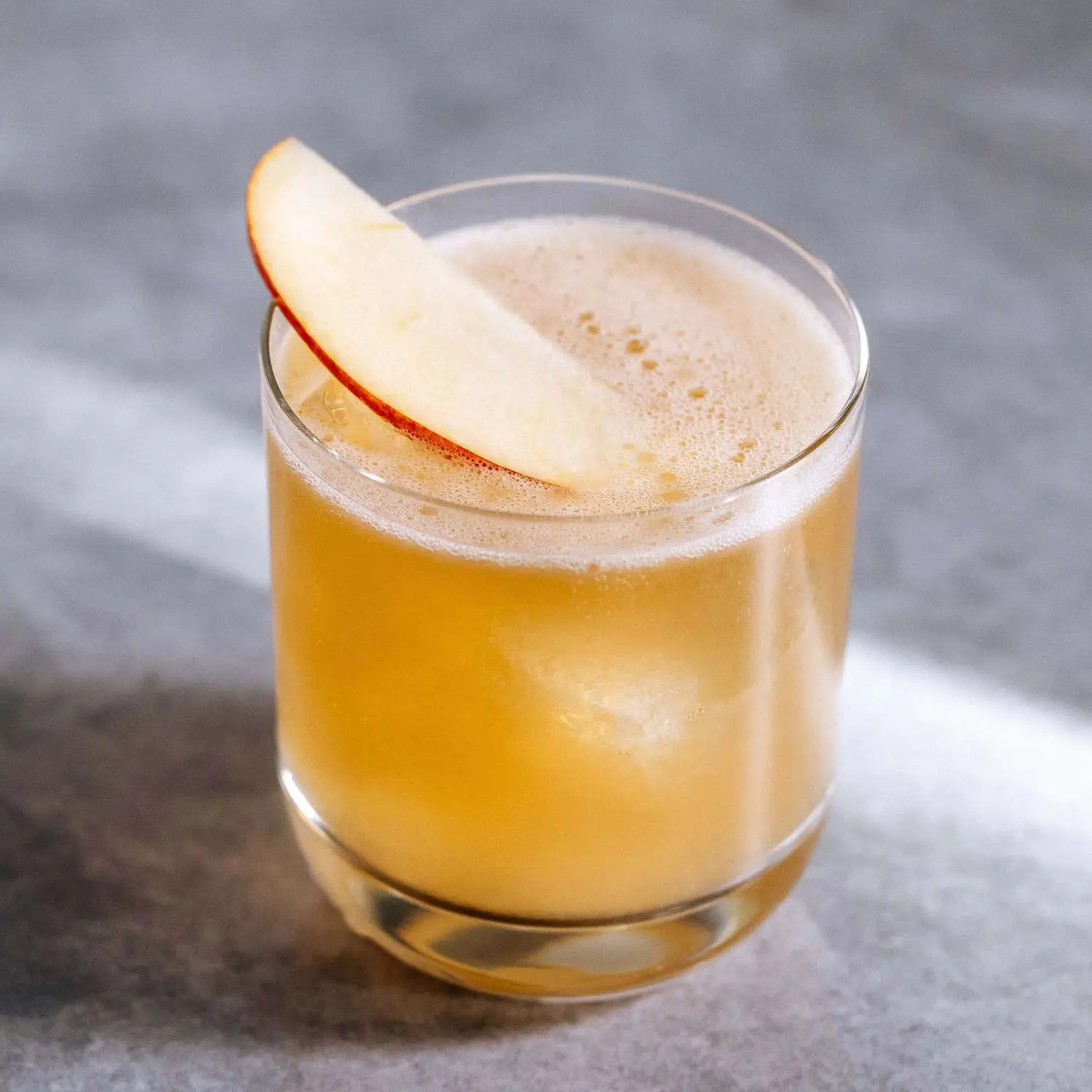 Cider Delighter cocktail in a rocks glass with apple slice garnish