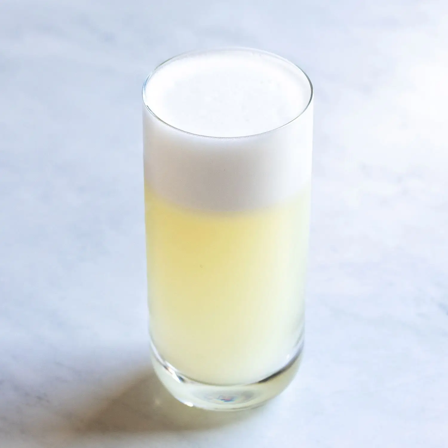 Gin Fizz in a highball glass with thick foam on top
