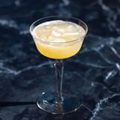 Corpse Reviver No. 2 in an old fashioned coupe glass on dark marble background