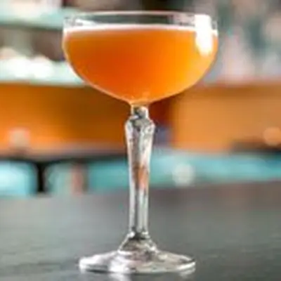 orange-hued Fall from the Tree cocktail in a coupe glass