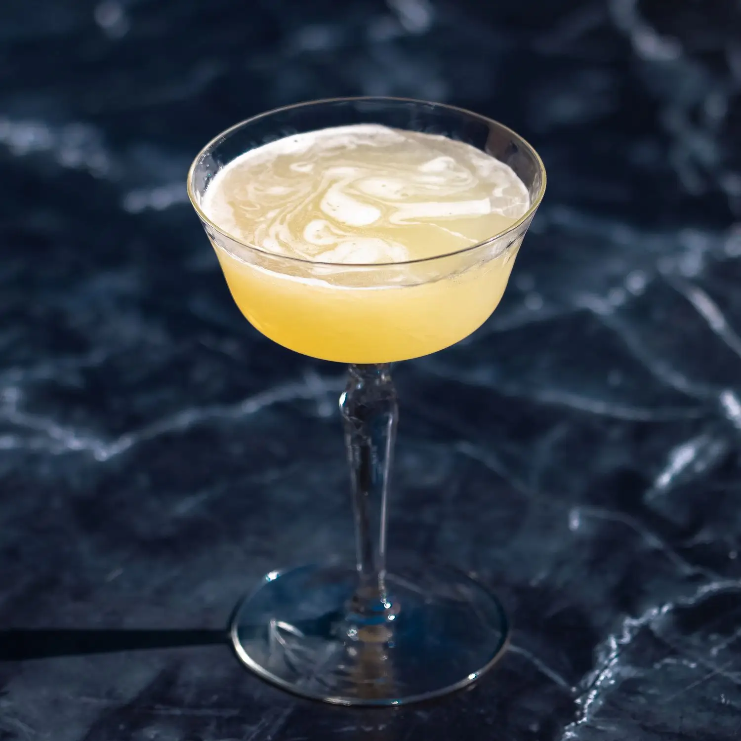 Corpse Reviver No. 2 in an old fashioned coupe glass on dark marble background