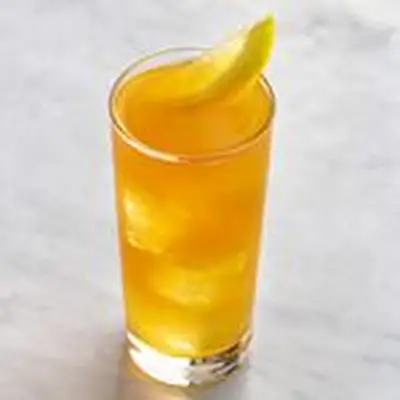 Backyard Iced Tea with lemon wedge garnish, served on white marble surface