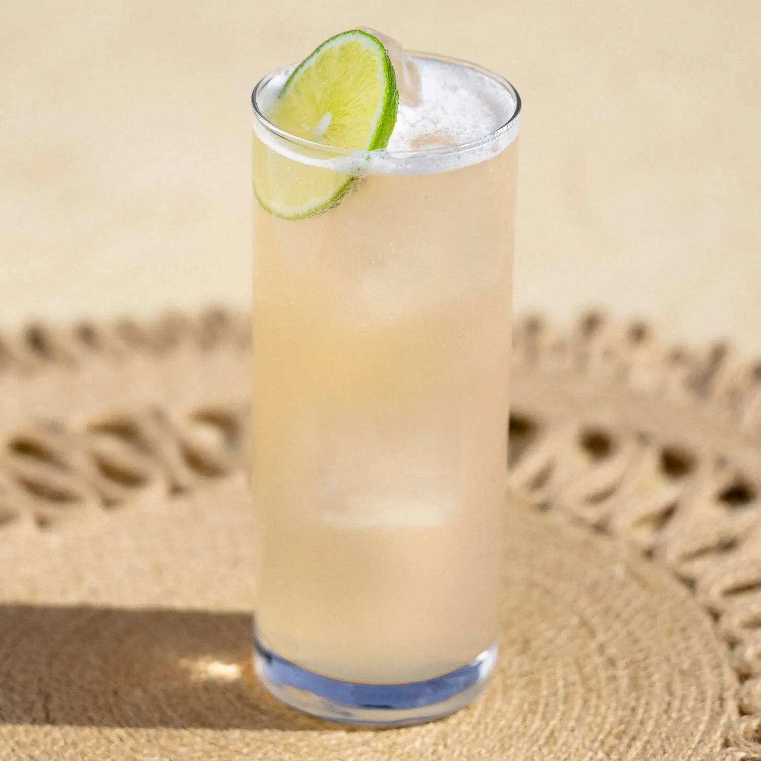 Paloma cocktail in a highball glass with a lime wheel