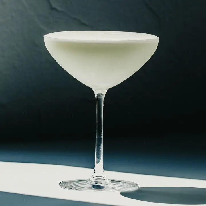 White Lady cocktail in a coupe glass against a dark background