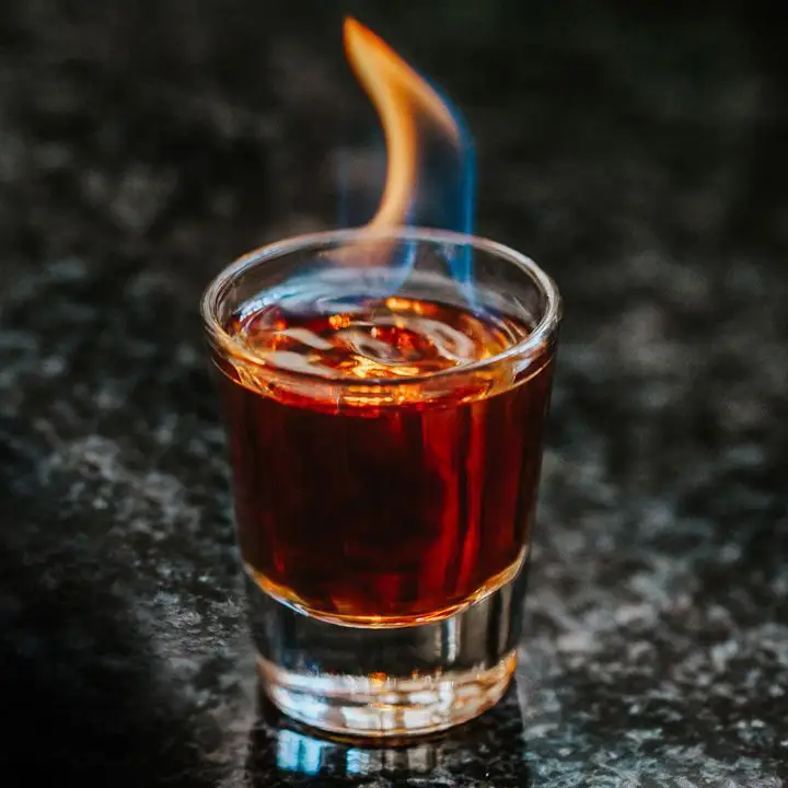 Flaming Dr. Pepper Shot served in a shot glass with a blue-and-orange flame