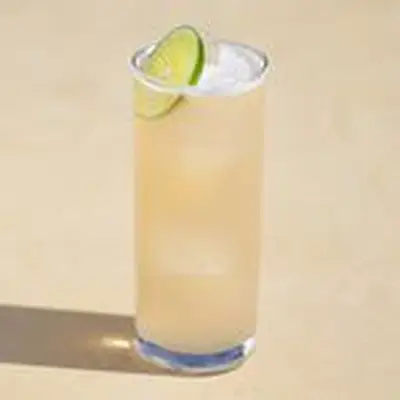 Paloma cocktail in a highball glass with a lime wheel