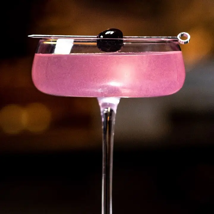 Rose cocktail garnished with brandied cherry
