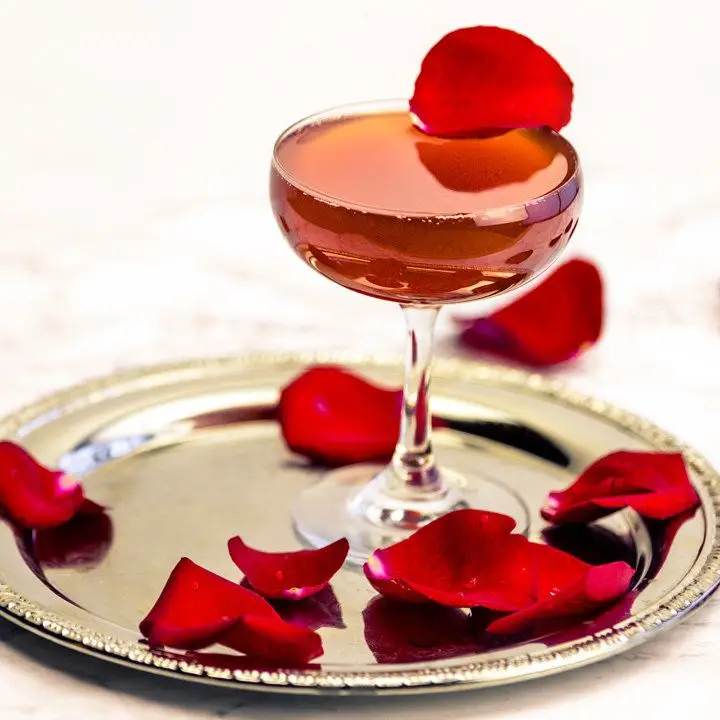 Rose Colored Glass cocktail garnished with rose petals