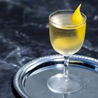 Smoky Martini with a lemon twist served on a metal tray