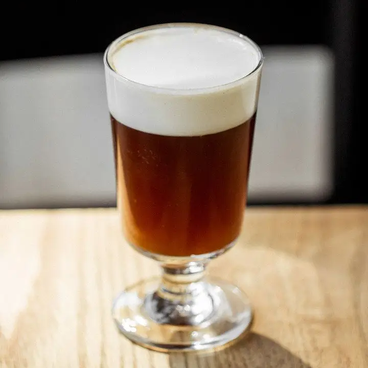 Rich Coffee cocktail with a white foamy head served in a short-stemmed glass