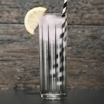 vodka soda cocktail with lemon wedge and black-and-white-striped straw