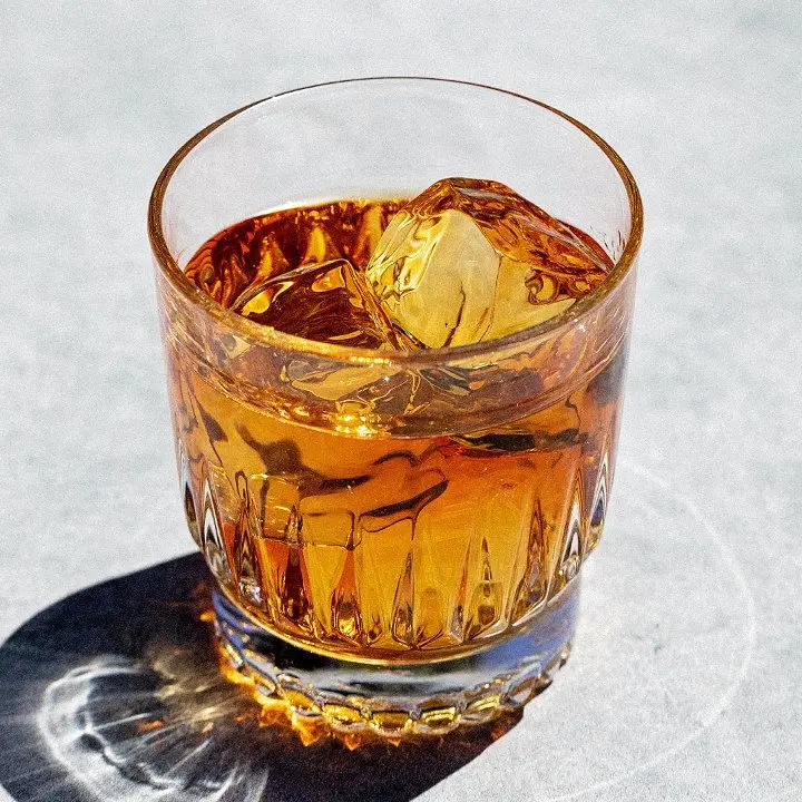 Brown & Orange cocktail in a rocks glass with clear ice cube