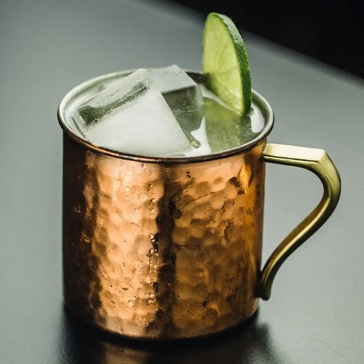 Moscow Mule cocktail in copper mug garnished with lime wheel