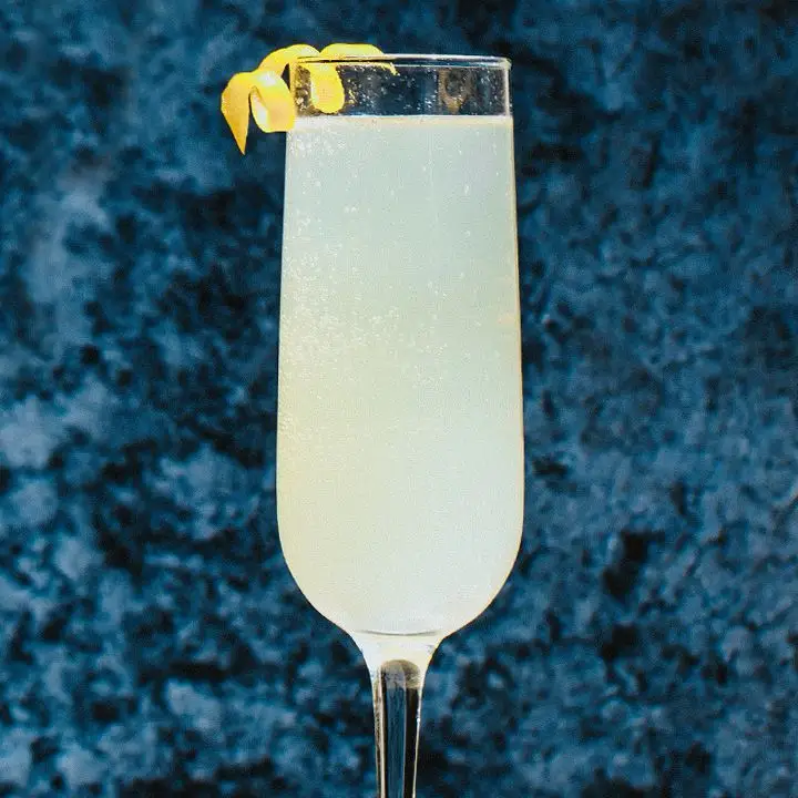 French 75 cocktail in champagne flute with lemon twist garnish