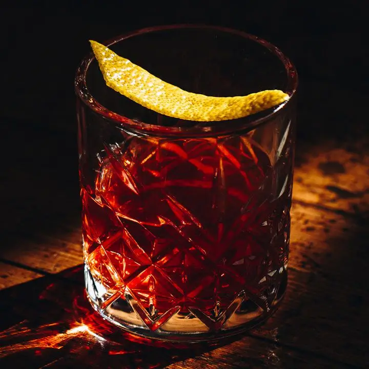 Sazerac cocktail garnished with lemon peel