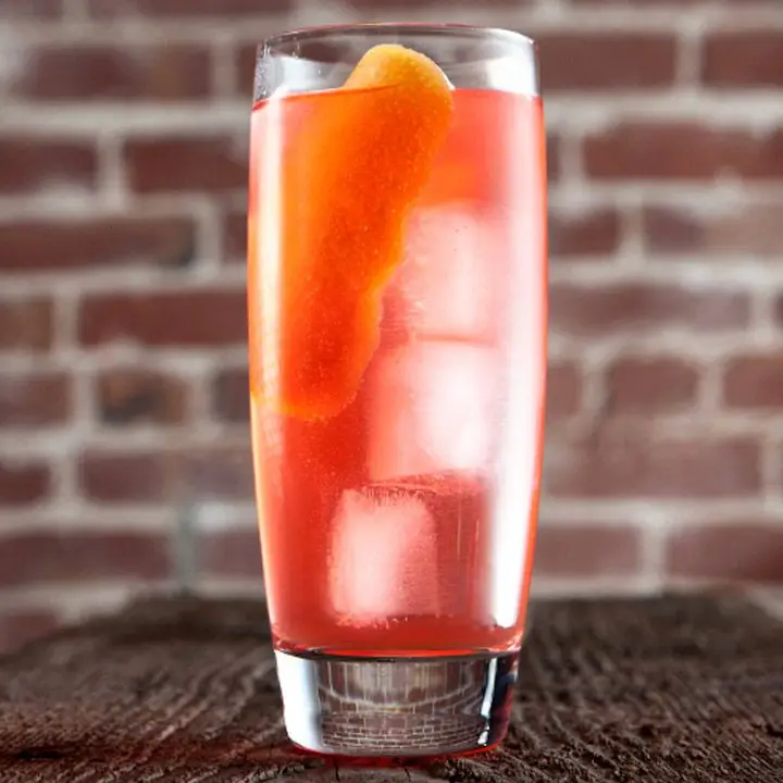 London Light cocktail in a highball glass with ice and a grapefruit peel