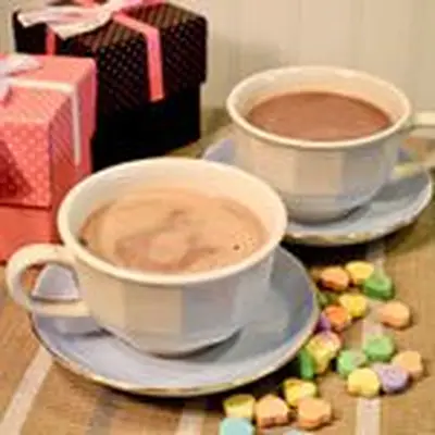 two I Left My Heart in Jalisco cocktails, served in coffee mugs next to conversation hearts