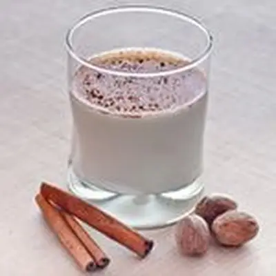 spiced rum milk punch with cinnamon sticks and nutmeg