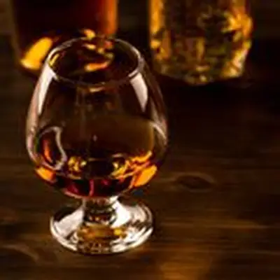 Armagnac in a small snifter with two bottles in the background