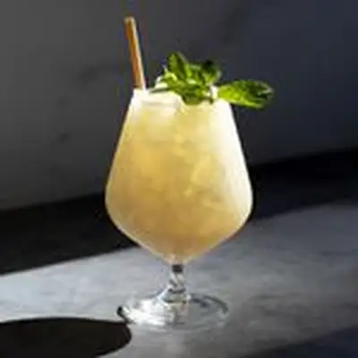 Absinthe Frappe cocktail garnished with mint sprig