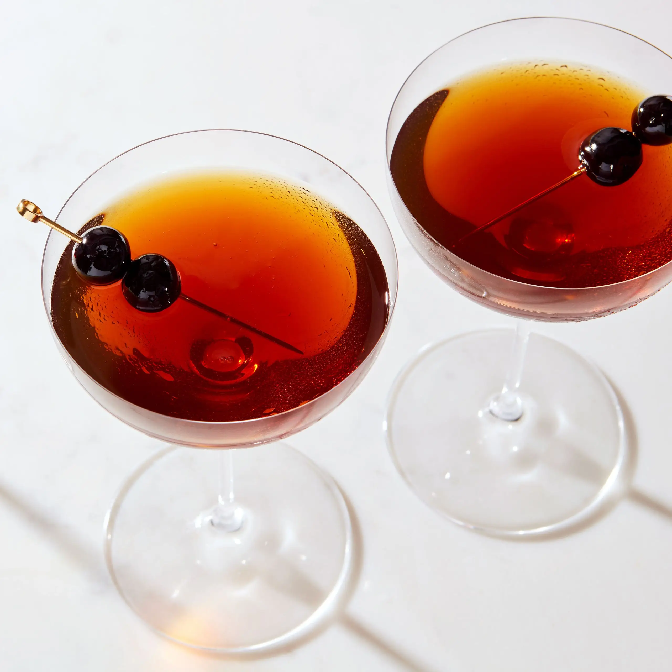 Photo of three glasses of a riff on the classic cocktail Little Italy.