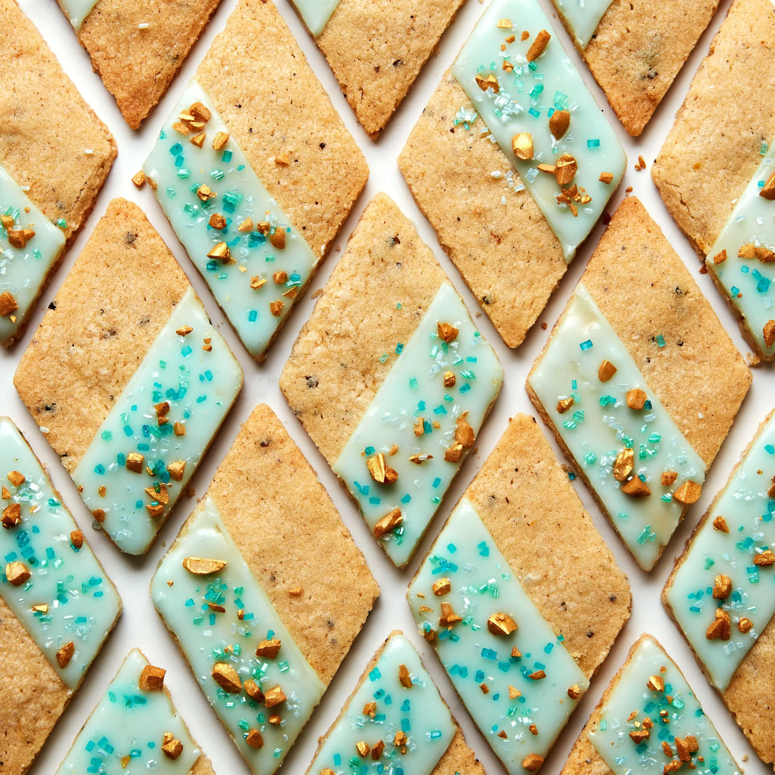 Photo of diamondshaped gingercardamom Christmas cookies with blue lemon icing.